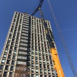 Ground Crane Working on Top of Building