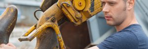 Man Standing by Crane Hook