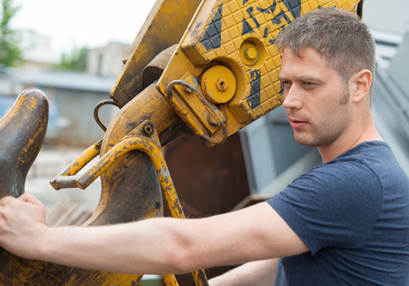 Man Standing by Crane Hook