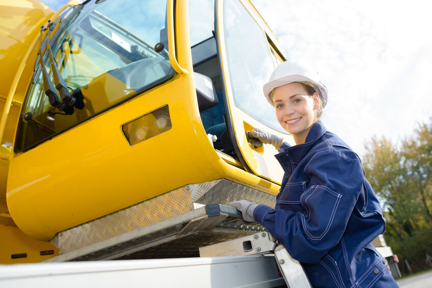 Experienced crane operator getting in her cab 