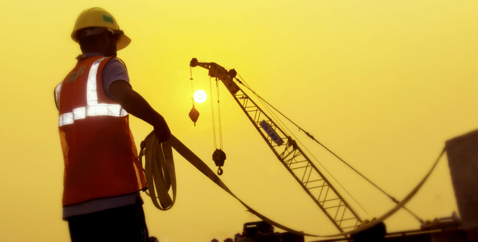 Worker doing maintenance on a construction crane